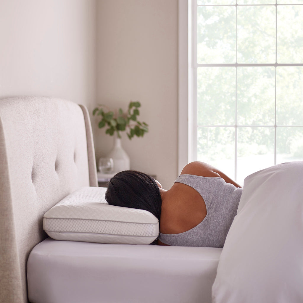Adjustable 3 Layer Memory Foam Pillow With a Model On A Bed