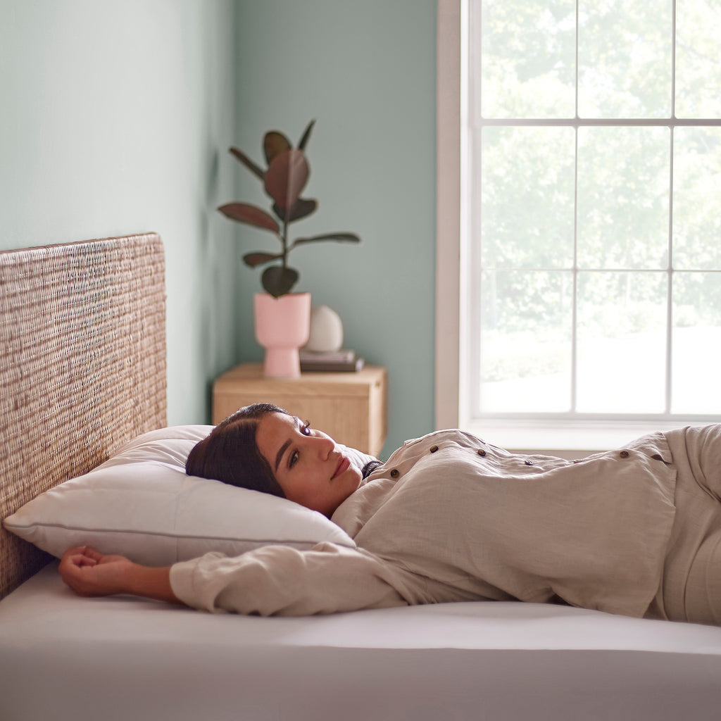 Natural Latex Foam Pillow on a bed with a model