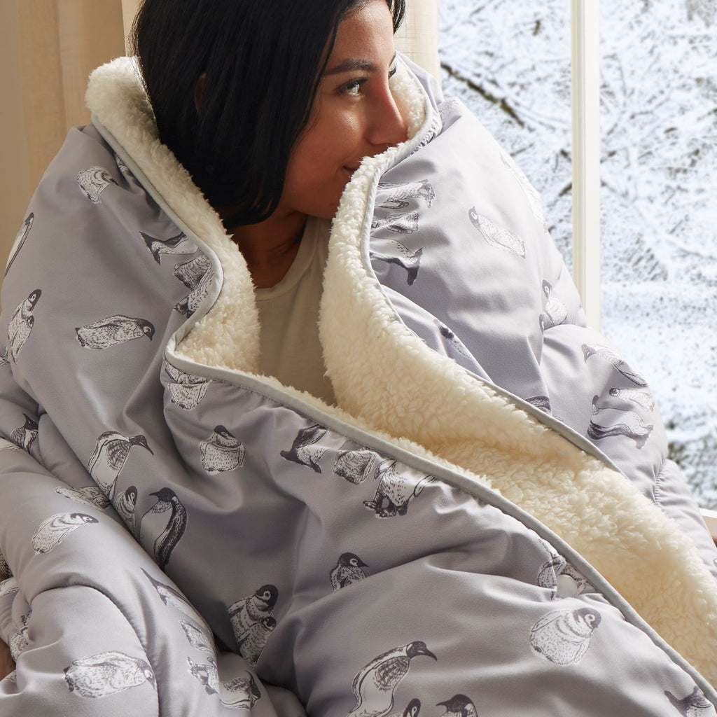 Night Lark® Cosy Sherpa Throw Winter Penguins on a model